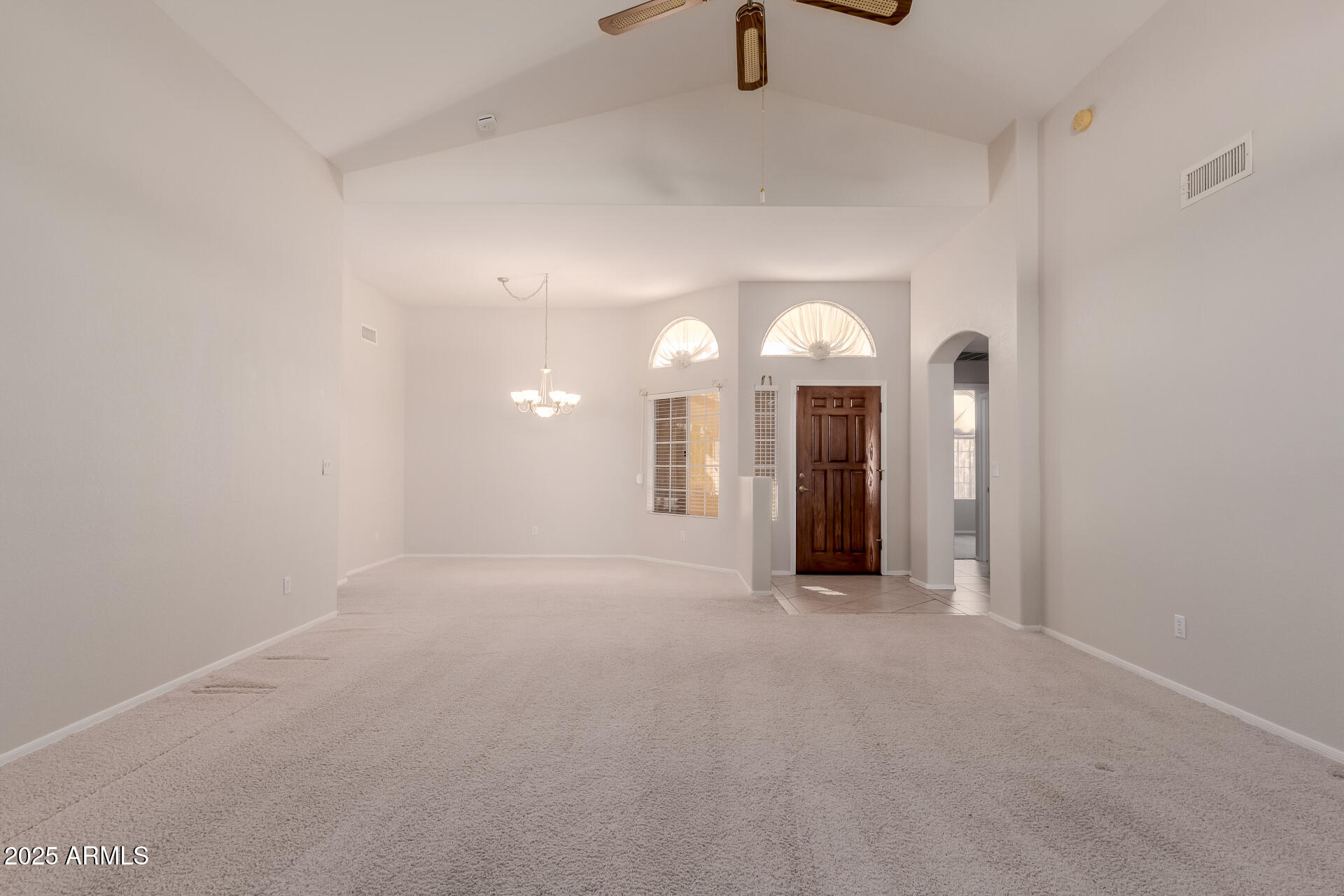 14588 West Bison Path Surprise, AZ 85374 - Photo 8 of 42 a view of a room with chandelier fan and windows