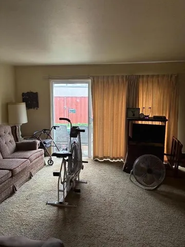 a view of a workspace with furniture and a window