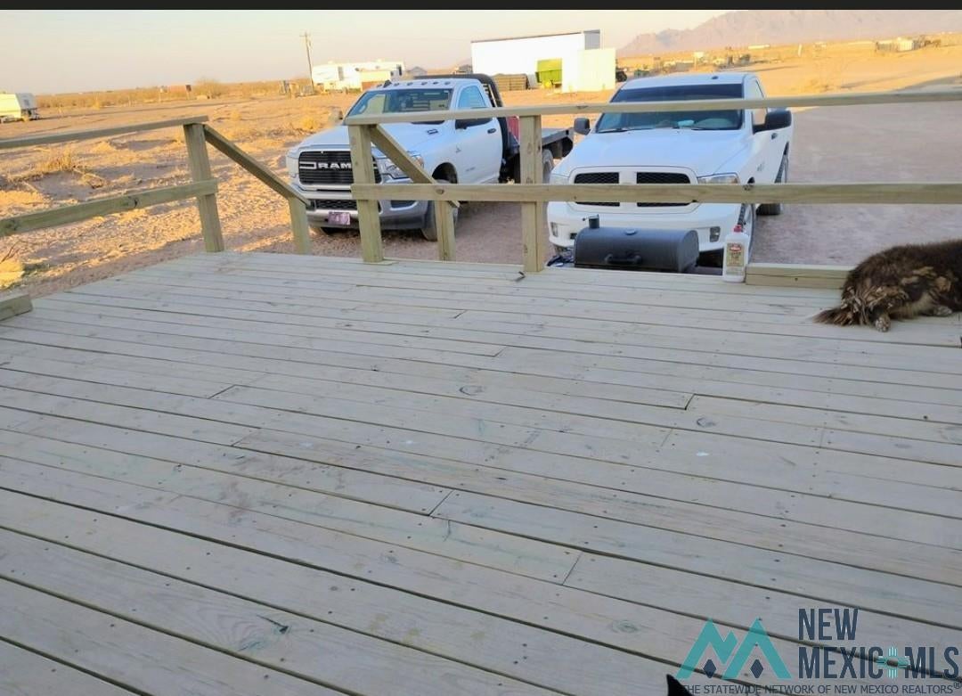 14006 Ciguena Road Southwest Deming, NM 88030 - Photo 17 of 49 Ground-level wood deck featuring a natural finish and a simple wood railing