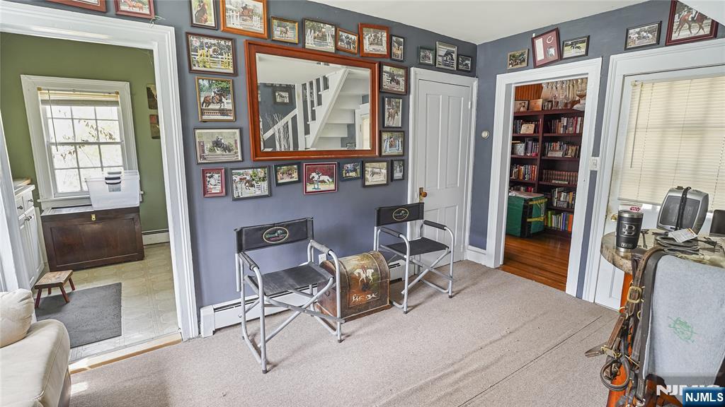 695 Ramapo Valley Road Oakland, NJ 07436 - Photo 36 of 42 a living room with furniture a flat screen tv and large window
