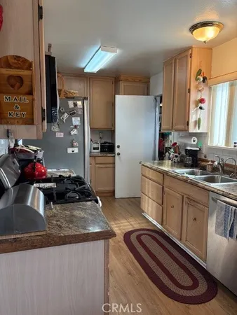 a kitchen with sink and refrigerator