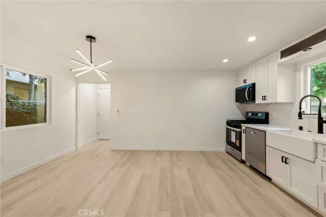 a view of a kitchen with electric appliances