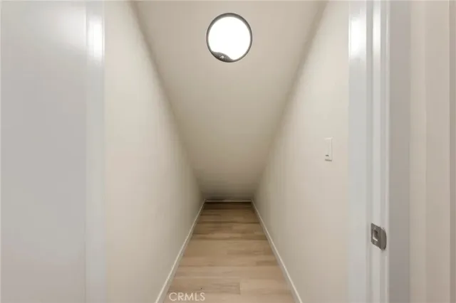 a view of a room with wooden floor and white walls