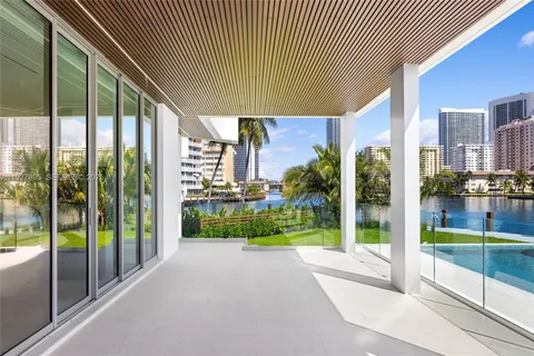 a view of a swimming pool with lawn chairs under an umbrella