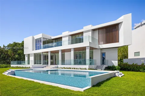 a view of a house with a backyard patio and swimming pool