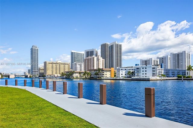 a front view of a house with plants