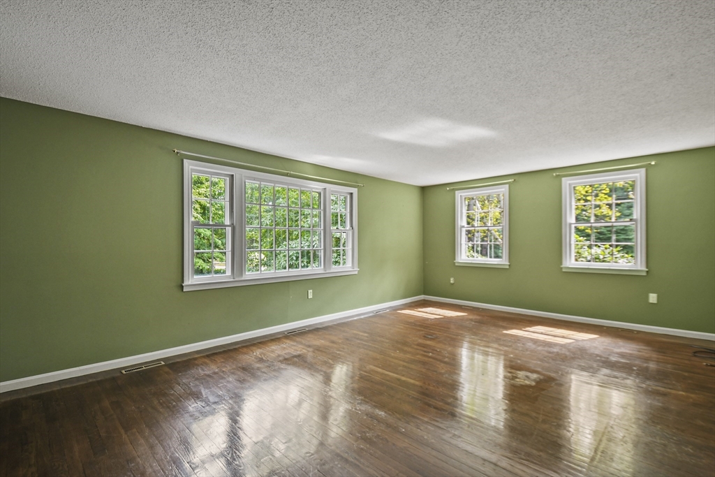 573 Main Street Dunstable, MA 01827 - Photo 14 of 42 a view of an empty room with wooden floor and a window