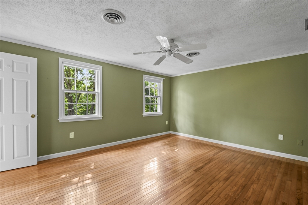 573 Main Street Dunstable, MA 01827 - Photo 17 of 42 a view of empty room with wooden floor and fan