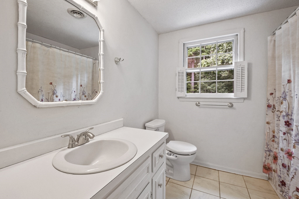 573 Main Street Dunstable, MA 01827 - Photo 24 of 42 a bathroom with a sink a toilet and a mirror