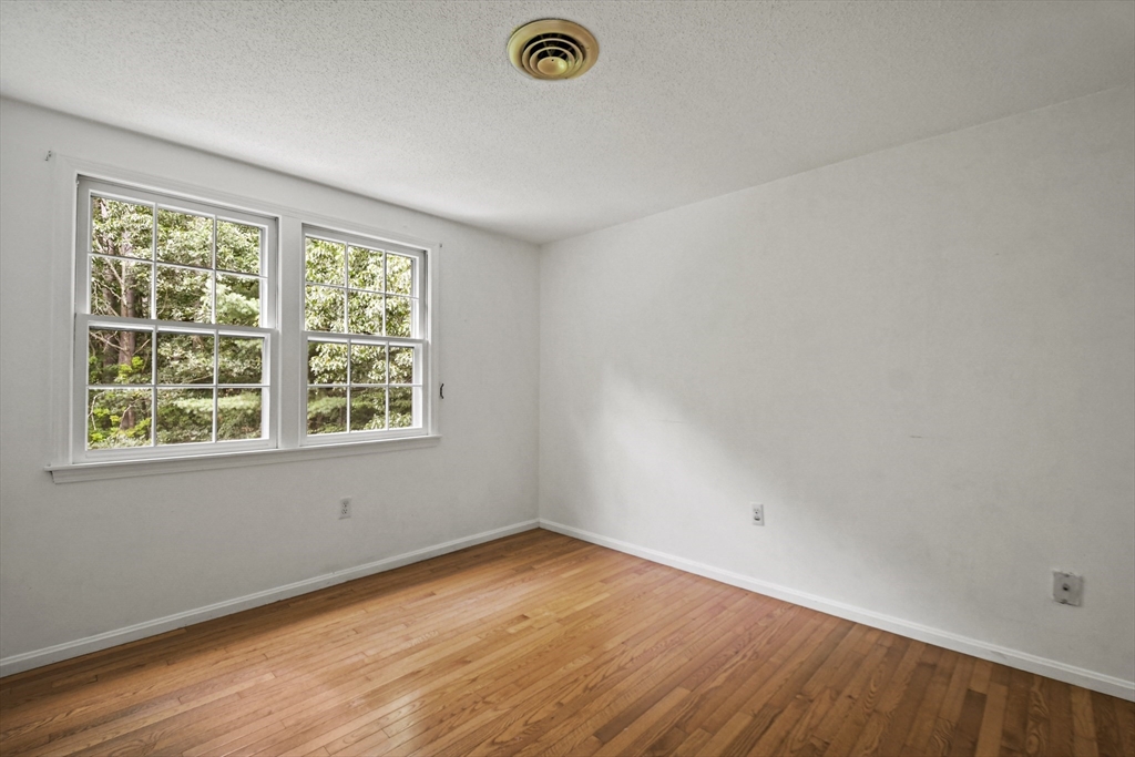 573 Main Street Dunstable, MA 01827 - Photo 25 of 42 an empty room with wooden floor and windows