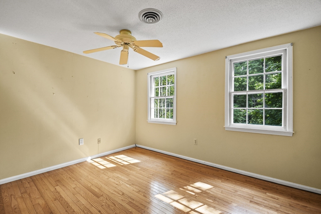 573 Main Street Dunstable, MA 01827 - Photo 27 of 42 an empty room with a window and ceiling fan