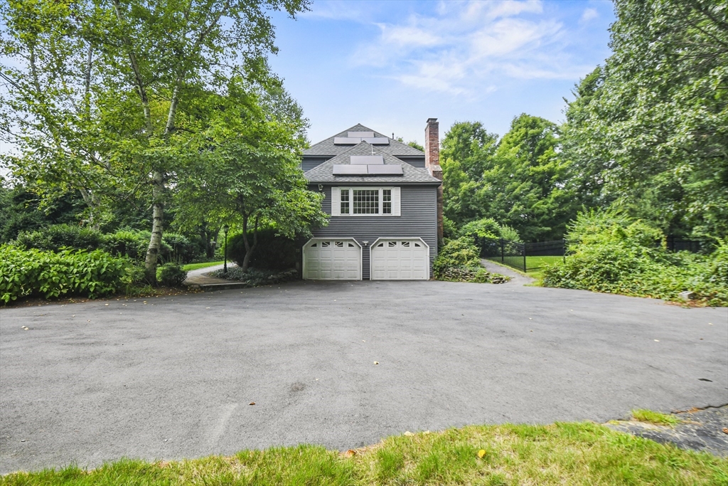 573 Main Street Dunstable, MA 01827 - Photo 35 of 42 a front view of a house with a yard and garage