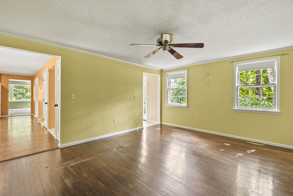 573 Main Street Dunstable, MA 01827 - Photo 4 of 42 a view of empty room with wooden floor and fan