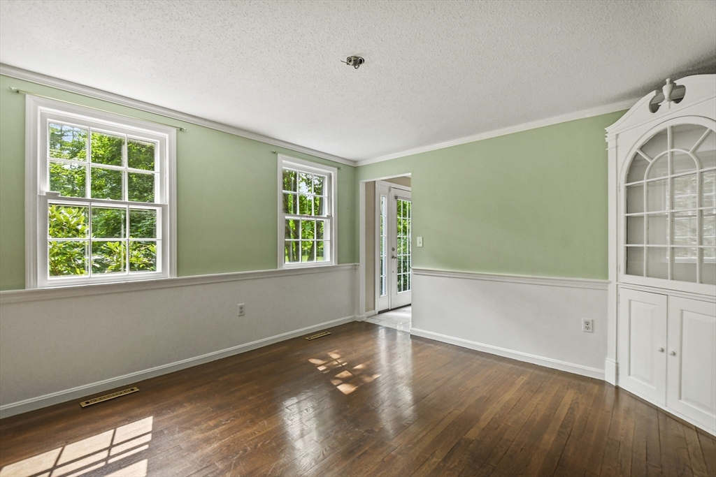 573 Main Street Dunstable, MA 01827 - Photo 5 of 42 an empty room with wooden floor and windows