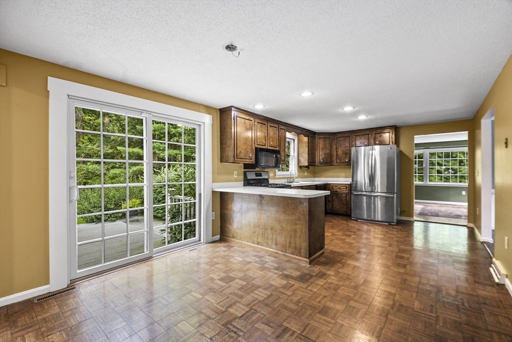 573 Main Street Dunstable, MA 01827 - Photo 10 of 42 a open kitchen with granite countertop a stove top oven a sink and a granite counter top