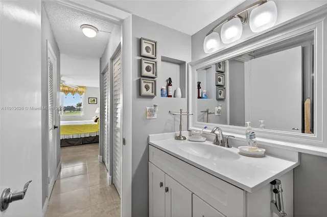 a bedroom with a bed and dresser with mirror