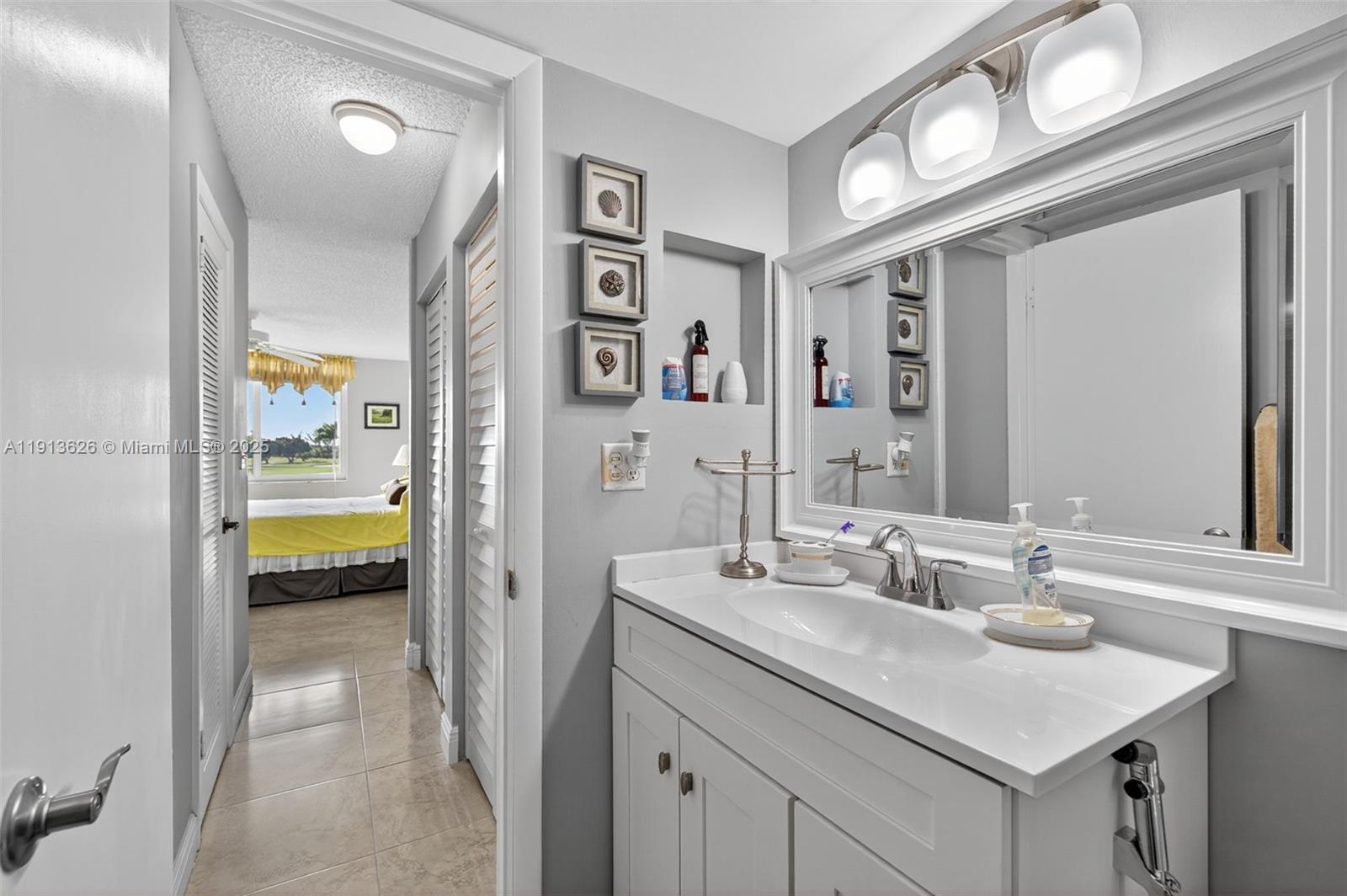 8900 Washington Street, Unit 410 Pembroke Pines, FL 33025 - Photo 15 of 79 a en suite bathroom with a sink and a mirror