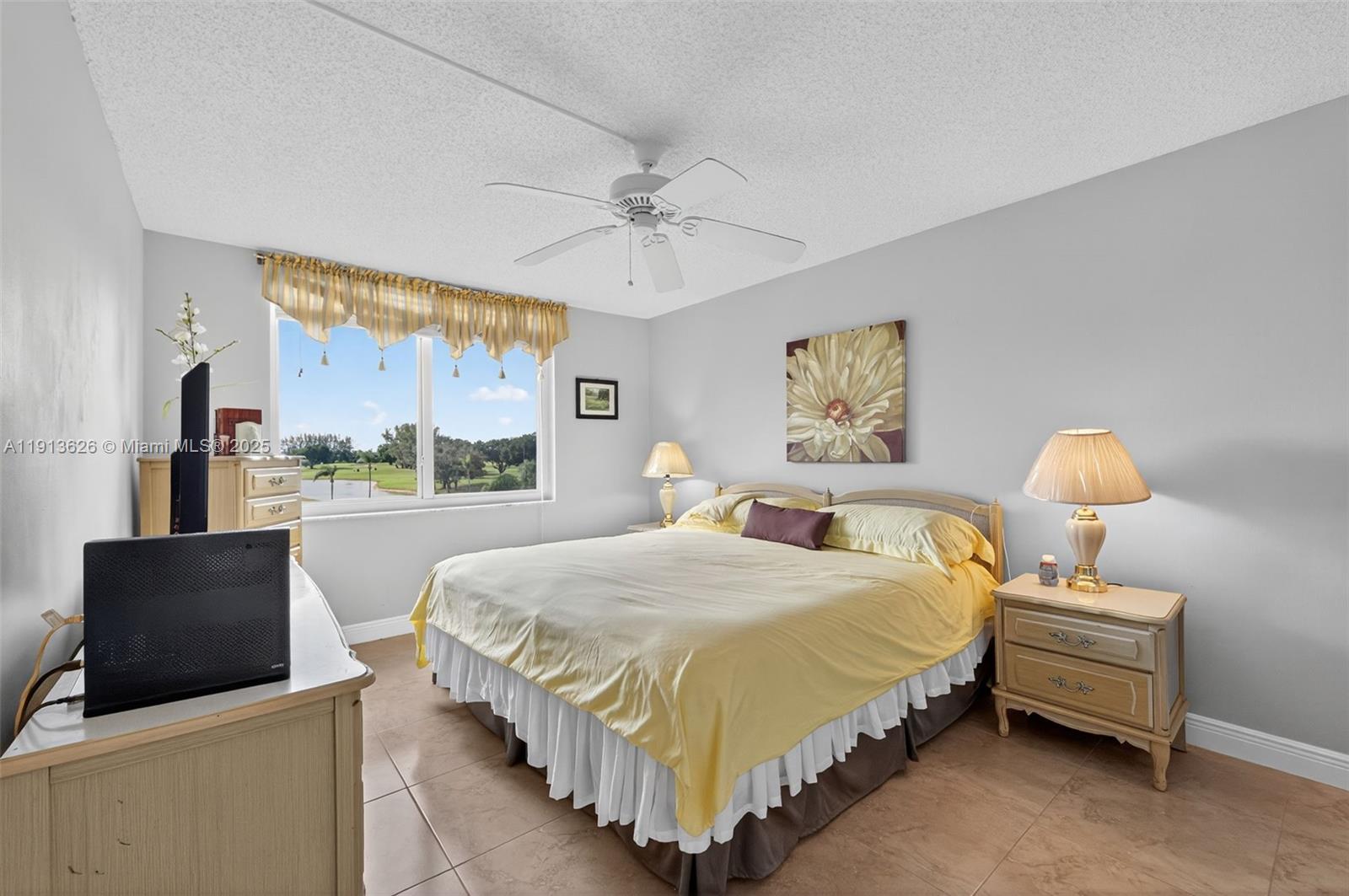 8900 Washington Street, Unit 410 Pembroke Pines, FL 33025 - Photo 18 of 79 a bedroom with a bed and dresser with mirror