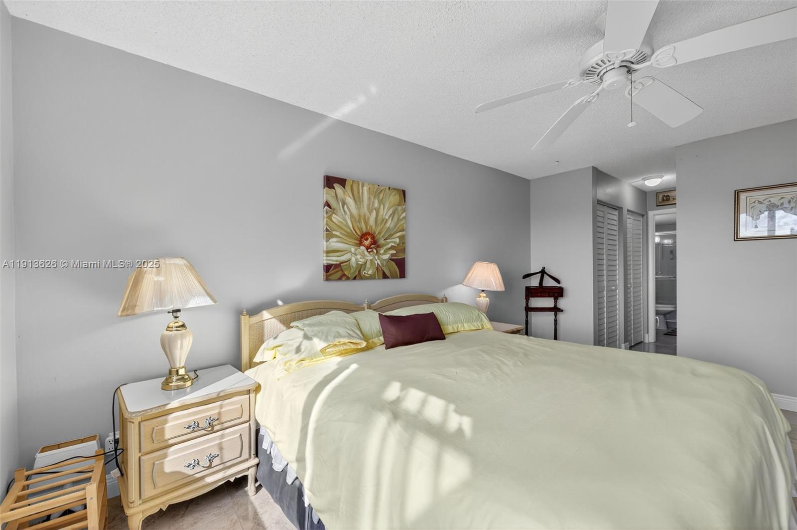 8900 Washington Street, Unit 410 Pembroke Pines, FL 33025 - Photo 19 of 79 a bedroom with bed and a chandelier