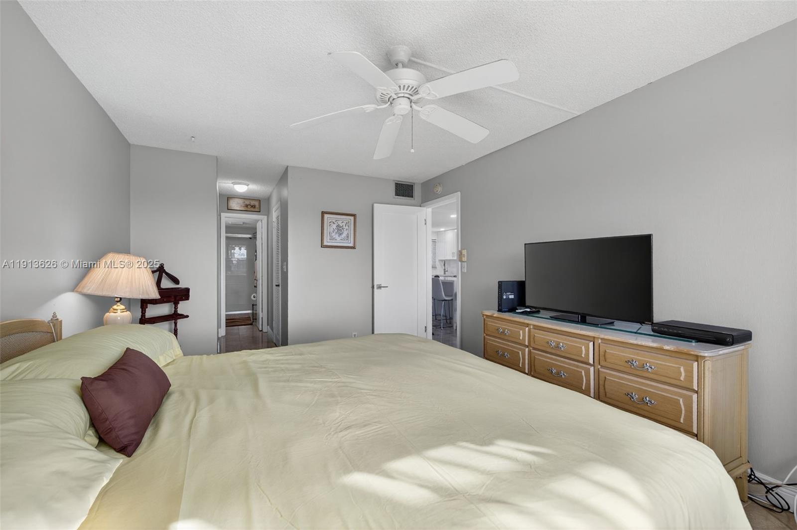 8900 Washington Street, Unit 410 Pembroke Pines, FL 33025 - Photo 20 of 79 a bedroom with a bed and a flat screen tv