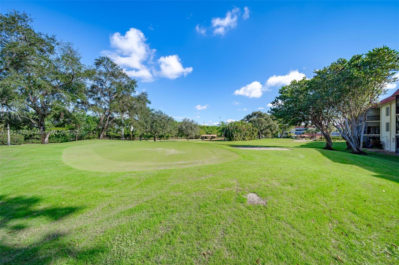 8900 Washington Street, Unit 410 Pembroke Pines, FL 33025 - Photo 30 of 79 a view of a golf course with a lake view