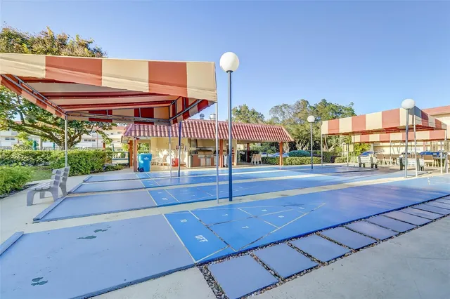 front view of house with a yard and potted plants