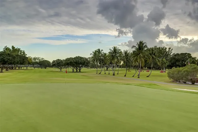 a group of people sitting under a large umbrella