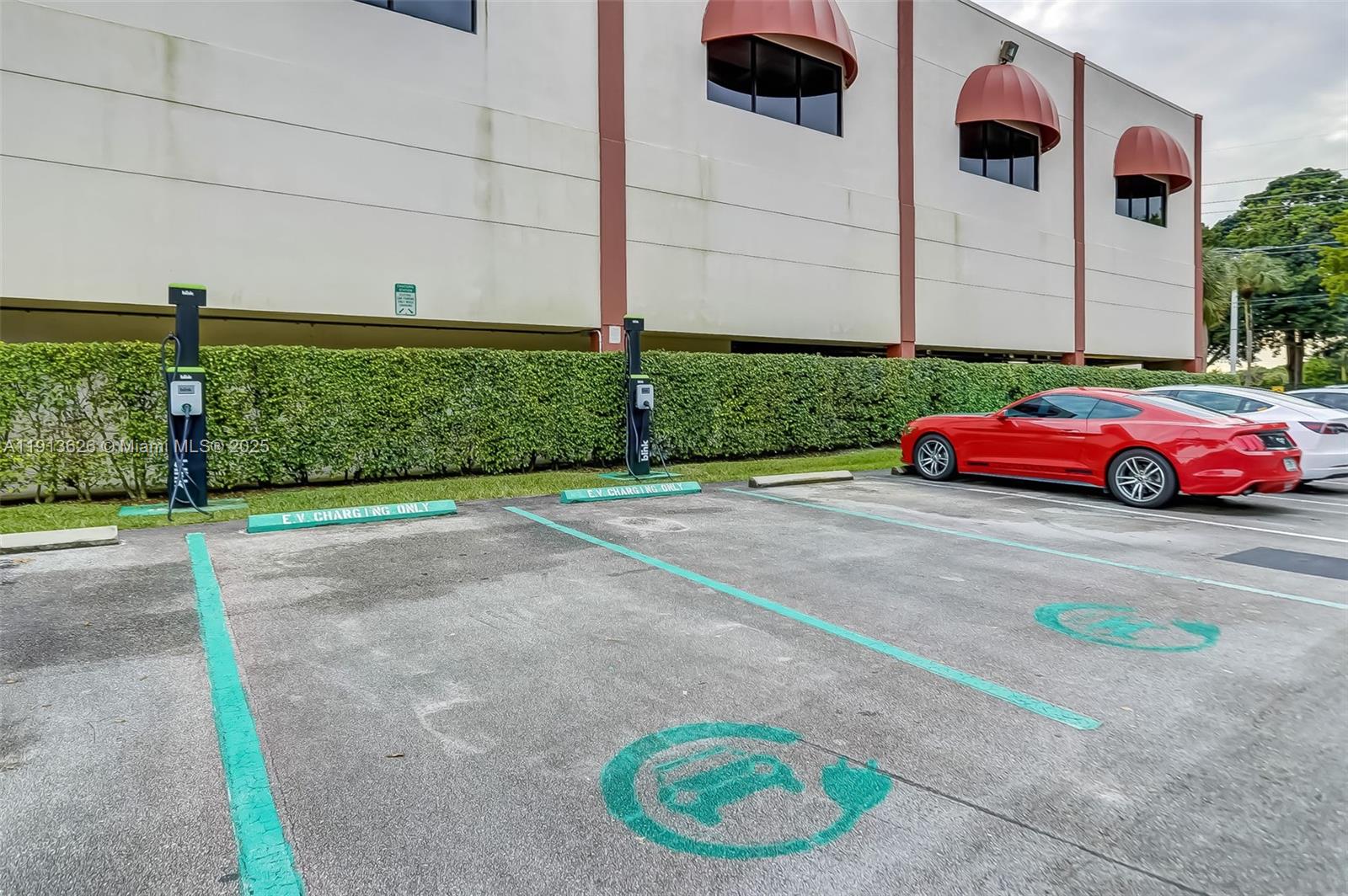 8900 Washington Street, Unit 410 Pembroke Pines, FL 33025 - Photo 46 of 79 a front view of a house with a yard and garage