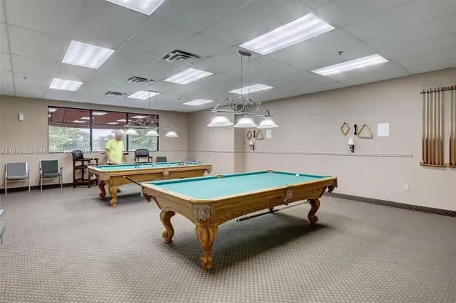 a living room with furniture a rug and a table