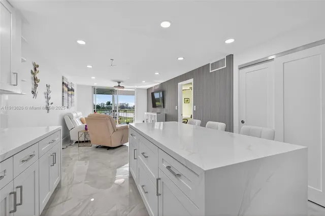a large white room with mirror and shower