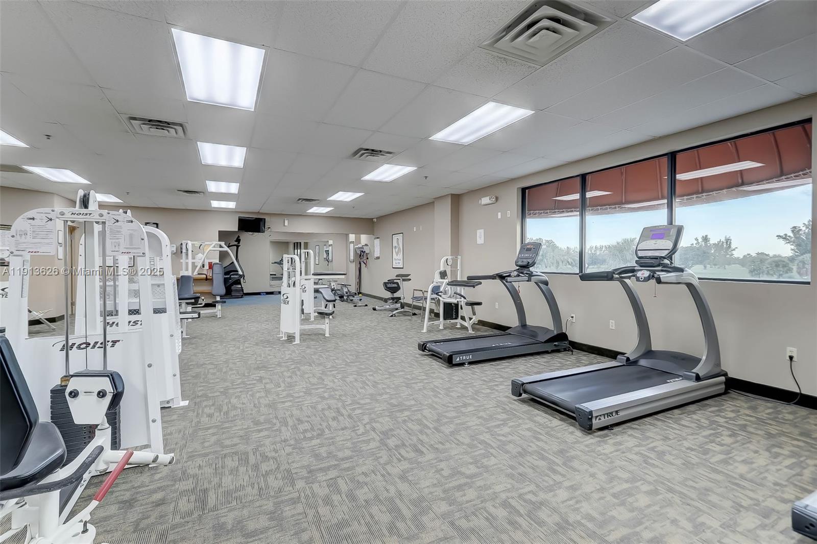 8900 Washington Street, Unit 410 Pembroke Pines, FL 33025 - Photo 56 of 79 a living room with furniture gym equipment and a large window