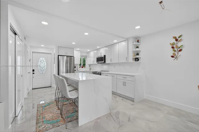 a large kitchen with a table and chairs