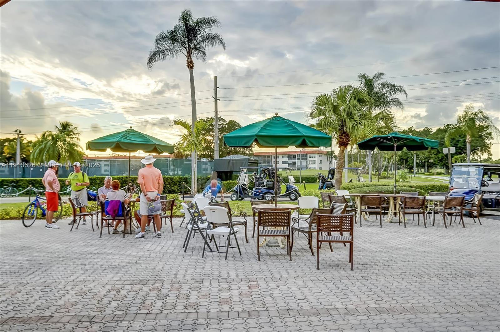 8900 Washington Street, Unit 410 Pembroke Pines, FL 33025 - Photo 66 of 79 a group of people sitting under a large umbrella