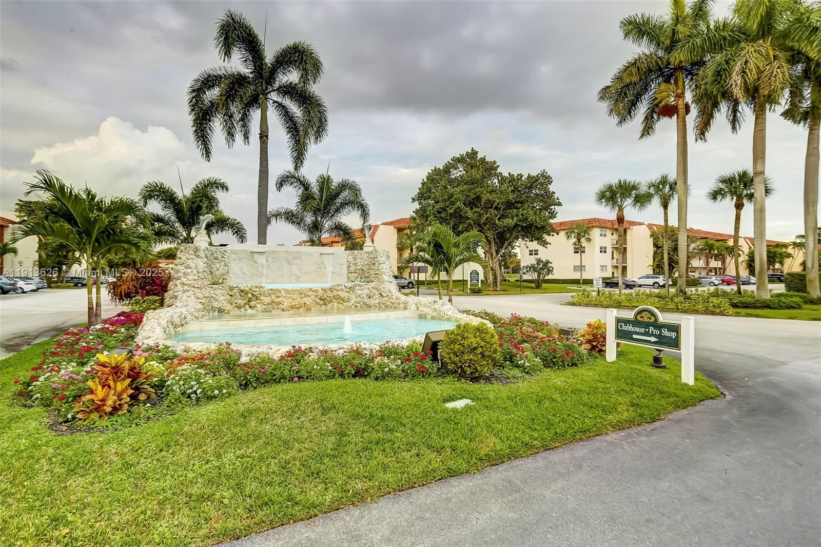 8900 Washington Street, Unit 410 Pembroke Pines, FL 33025 - Photo 67 of 79 a view of a swimming pool with a garden and palm trees