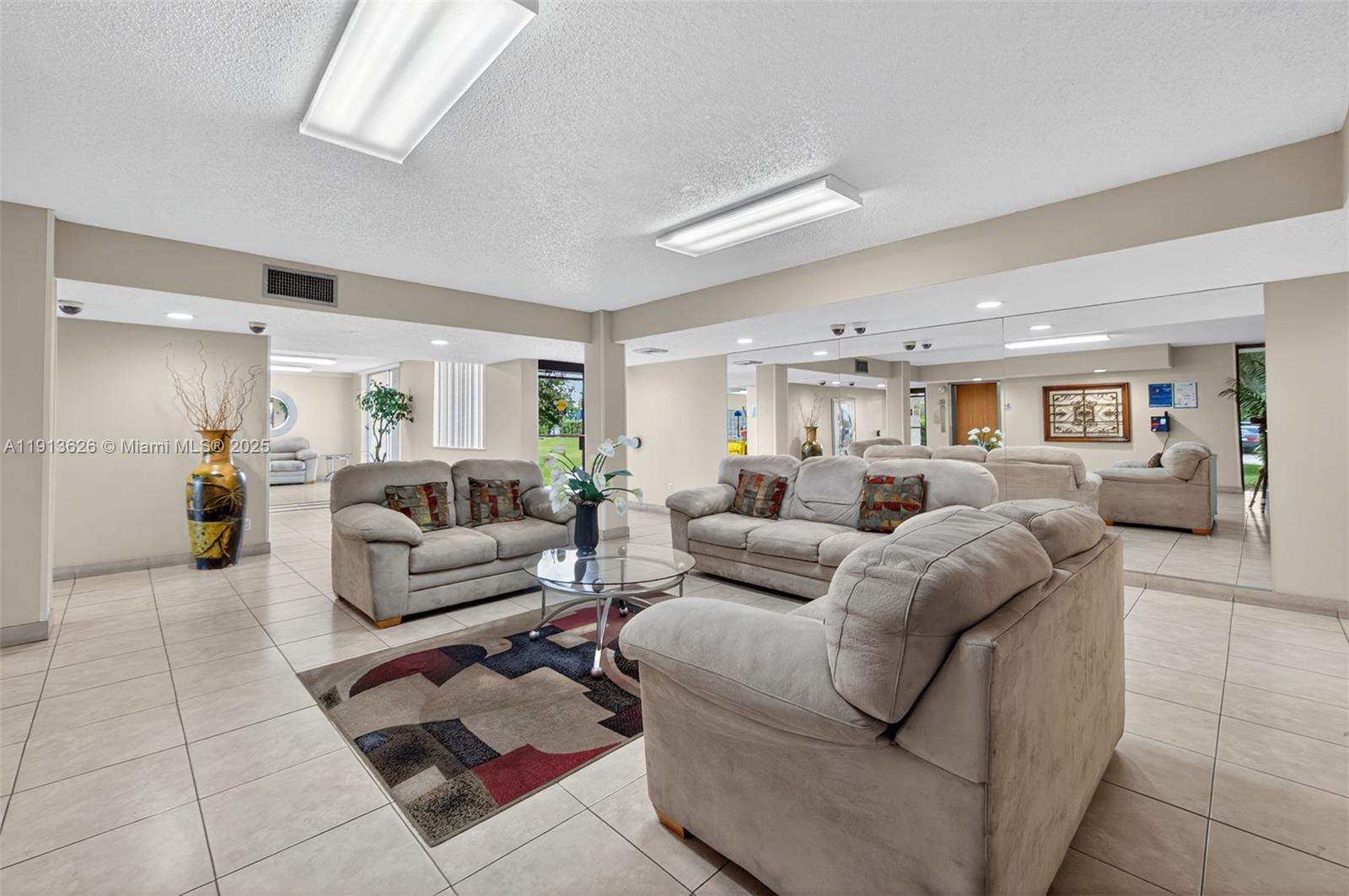 8900 Washington Street, Unit 410 Pembroke Pines, FL 33025 - Photo 76 of 79 a living room with furniture and wooden floor