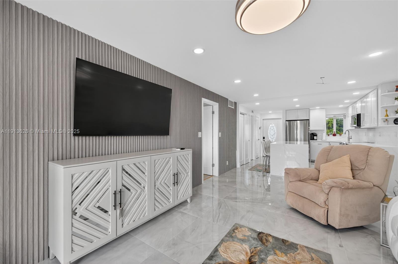 8900 Washington Street, Unit 410 Pembroke Pines, FL 33025 - Photo 9 of 79 a living room with furniture and a flat screen tv