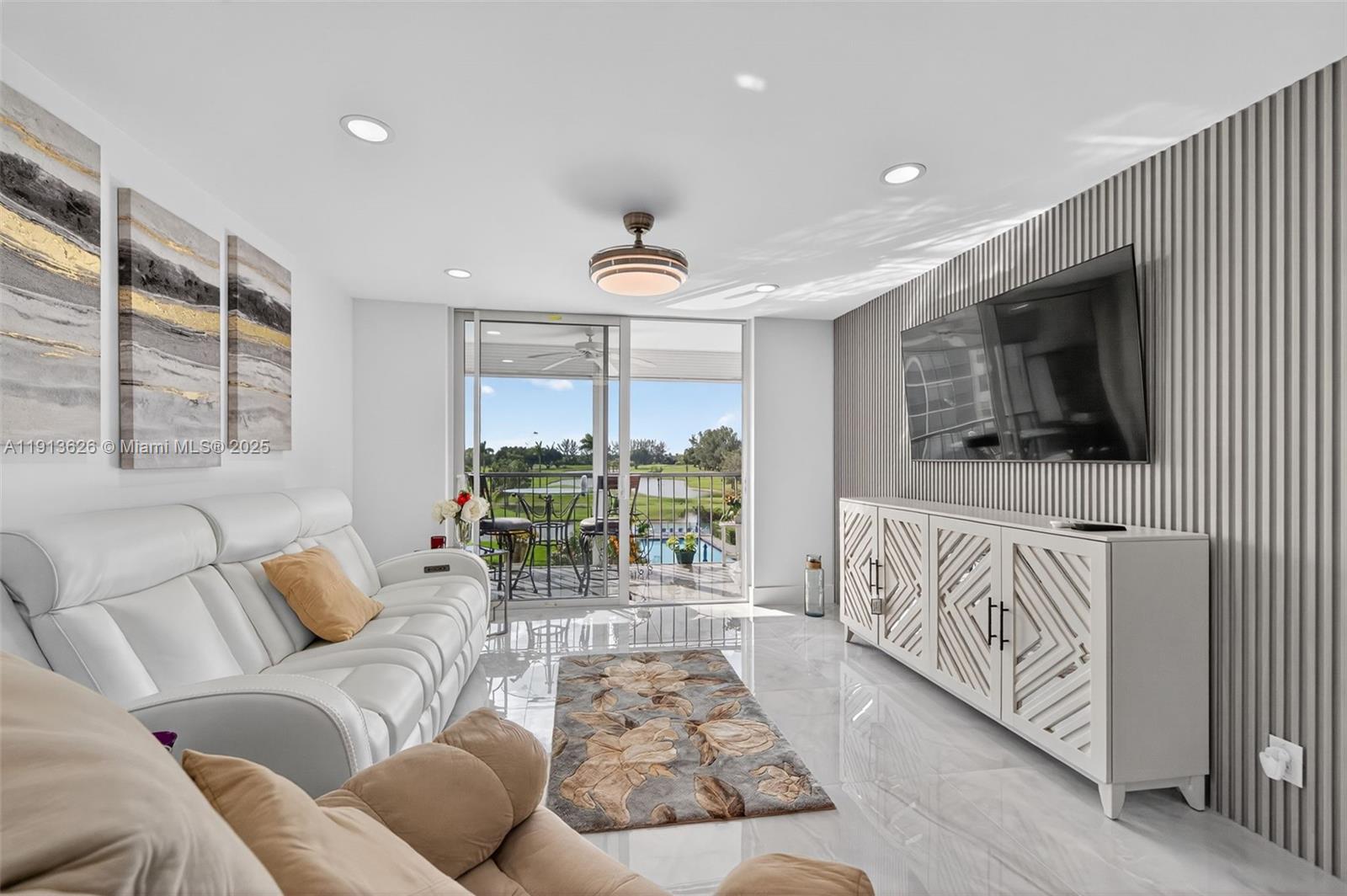 8900 Washington Street, Unit 410 Pembroke Pines, FL 33025 - Photo 10 of 79 a living room with furniture and a flat screen tv