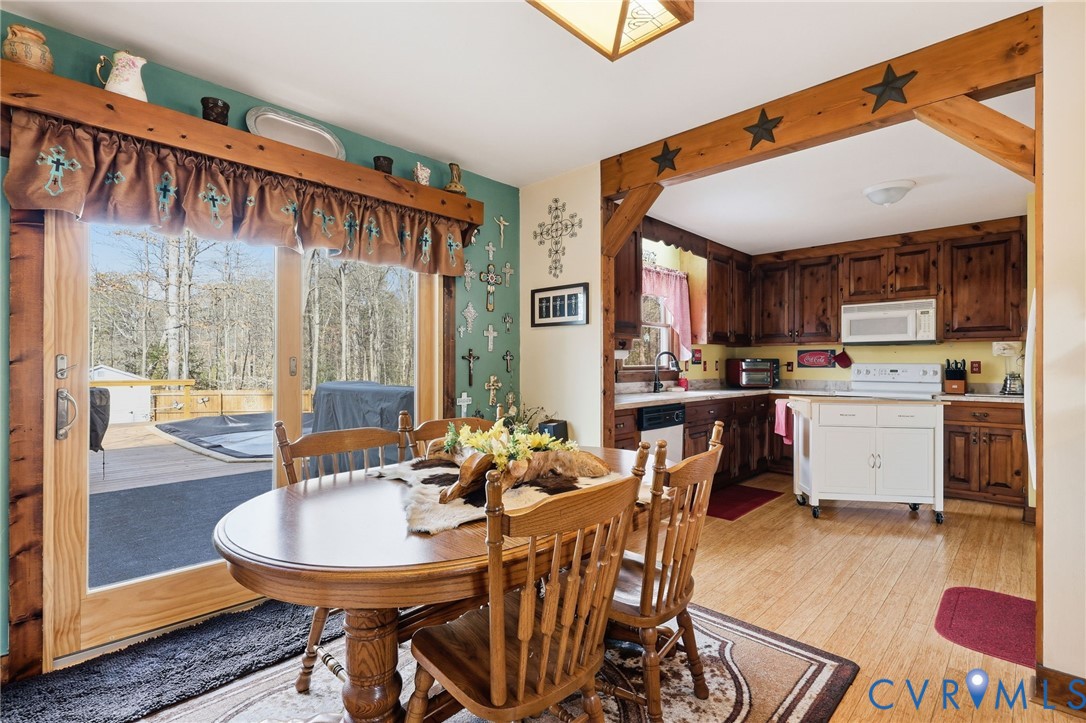 4022 Evelake Road Richmond, VA 23237 - Photo 17 of 35 a dining room with stainless steel appliances a table and chairs