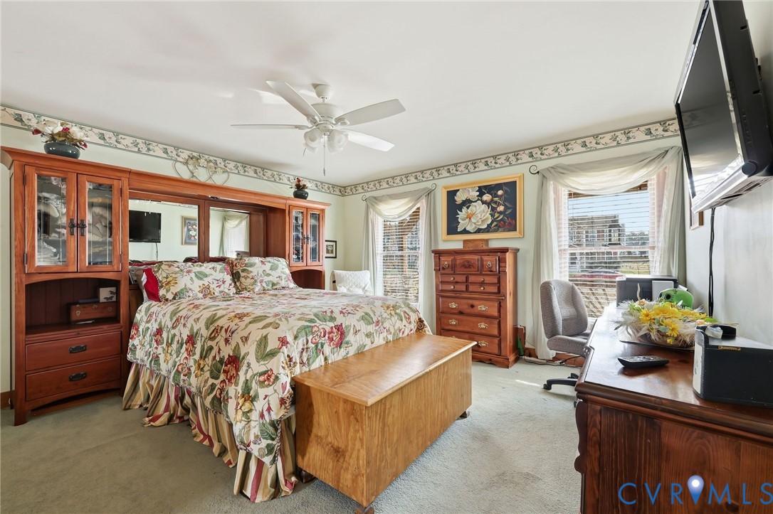 4022 Evelake Road Richmond, VA 23237 - Photo 22 of 35 a bedroom with a bed couch and a window
