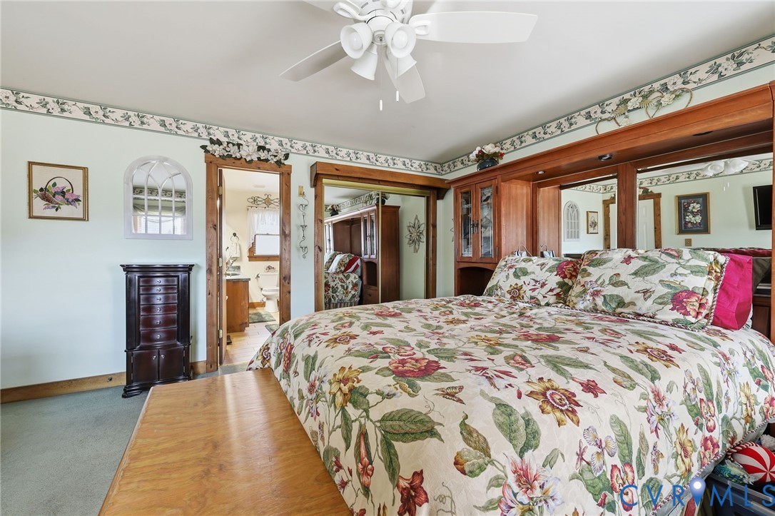 4022 Evelake Road Richmond, VA 23237 - Photo 23 of 35 a bed sitting in a bedroom next to a window