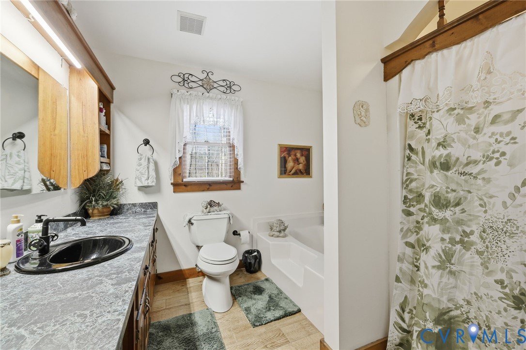 4022 Evelake Road Richmond, VA 23237 - Photo 24 of 35 a bathroom with a sink toilet and mirror