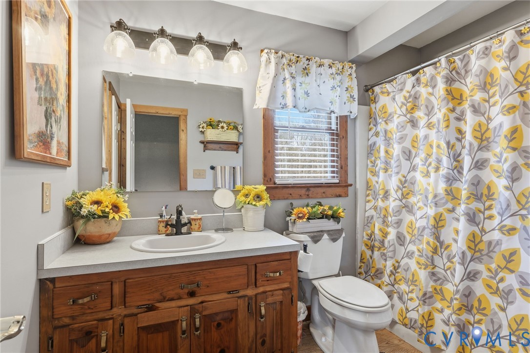 4022 Evelake Road Richmond, VA 23237 - Photo 31 of 35 a bathroom with a sink a toilet and shower curtain