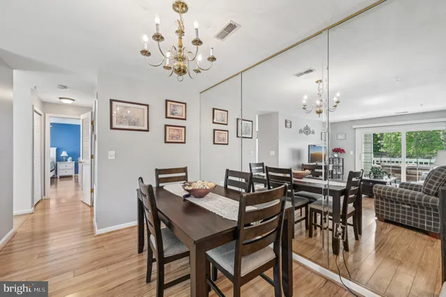 a view of a dining room with furniture wooden floor and chandelier