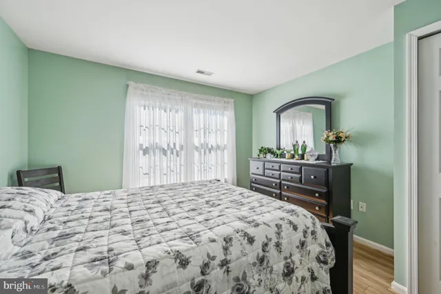 a bedroom with a bed and a dresser