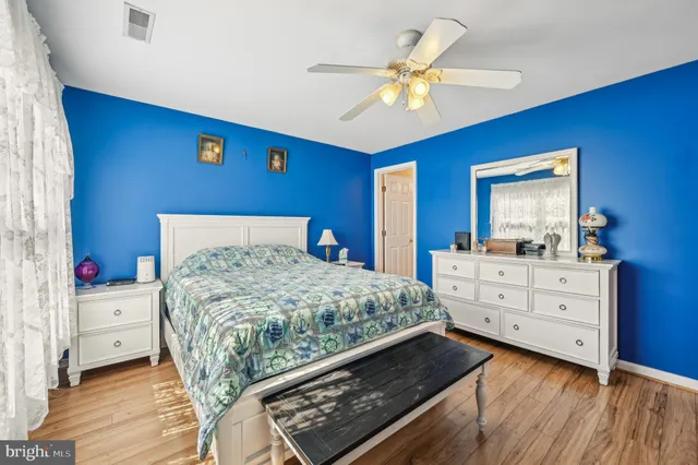 a bedroom with a bed and a dresser in it