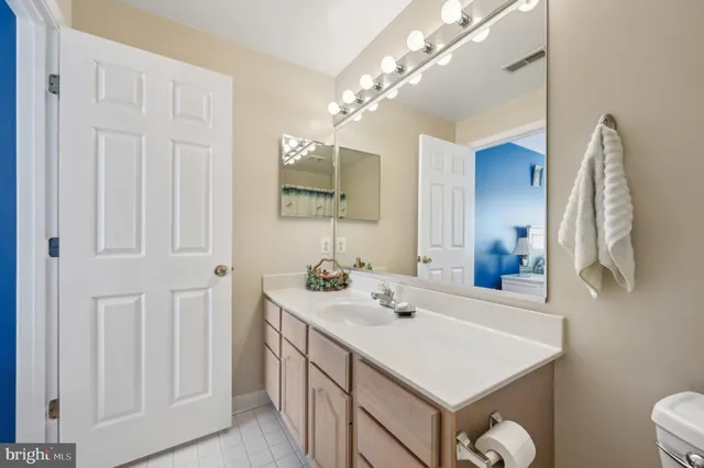 a bathroom with a sink vanity and a mirror