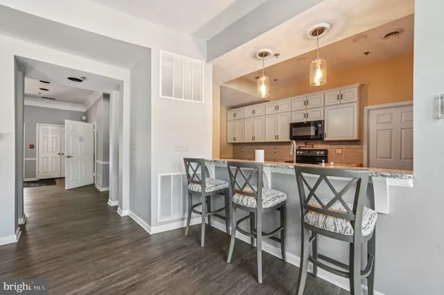 a view of a dining room with furniture and wooden floor