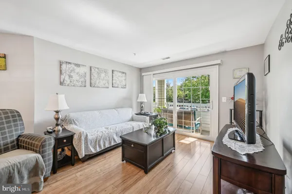 a living room with furniture window and a wooden floor