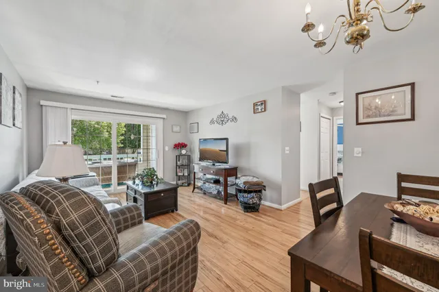 a living room with furniture a flat screen tv and a window
