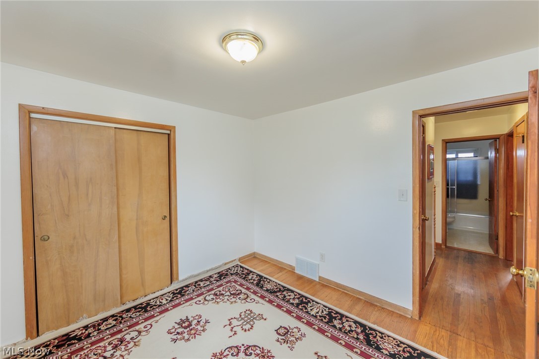 6147 Holburn Road Cleveland, OH 44129 - Photo 35 of 45 Unfurnished bedroom featuring a closet and wood-type flooring